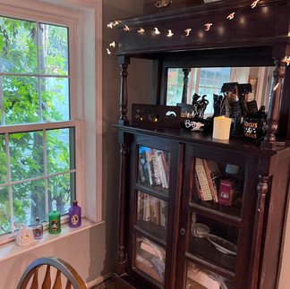 Halloween decorations on a bookcase in a home.