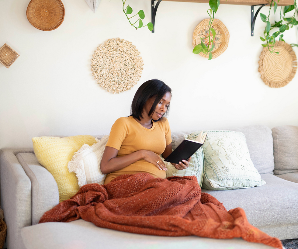 Woman Reading a book on her couch.