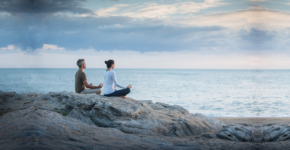 Couple meditate beach AdobeStock_1698634