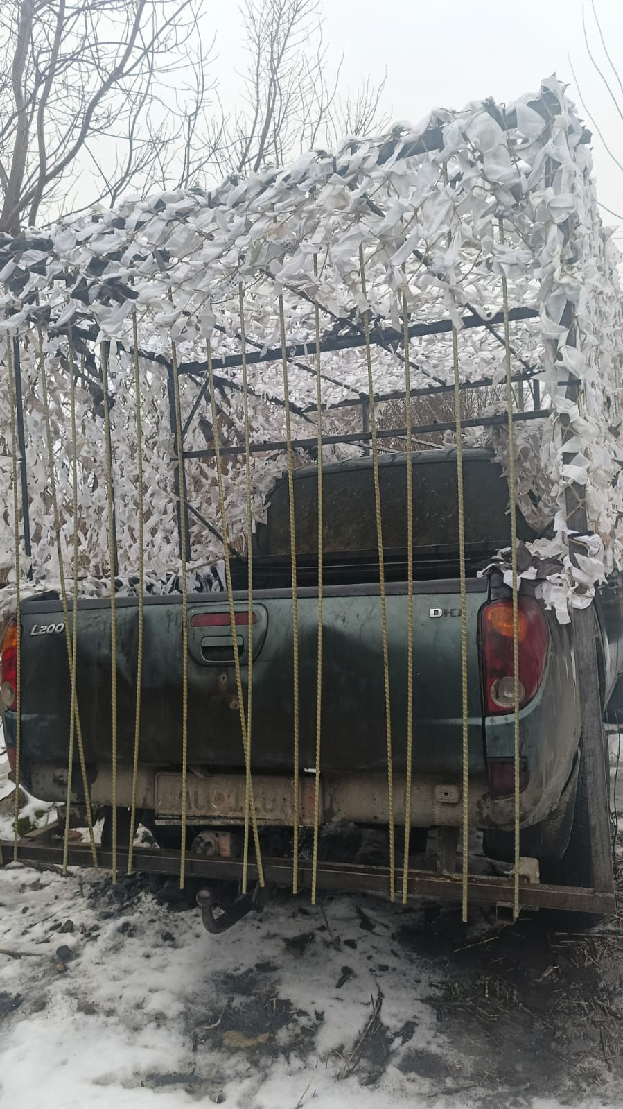 A pickup truck from an earlier convoy. Barely recognizable with a drone defense device. It transports medical aid to remote locations and wherever it is needed.