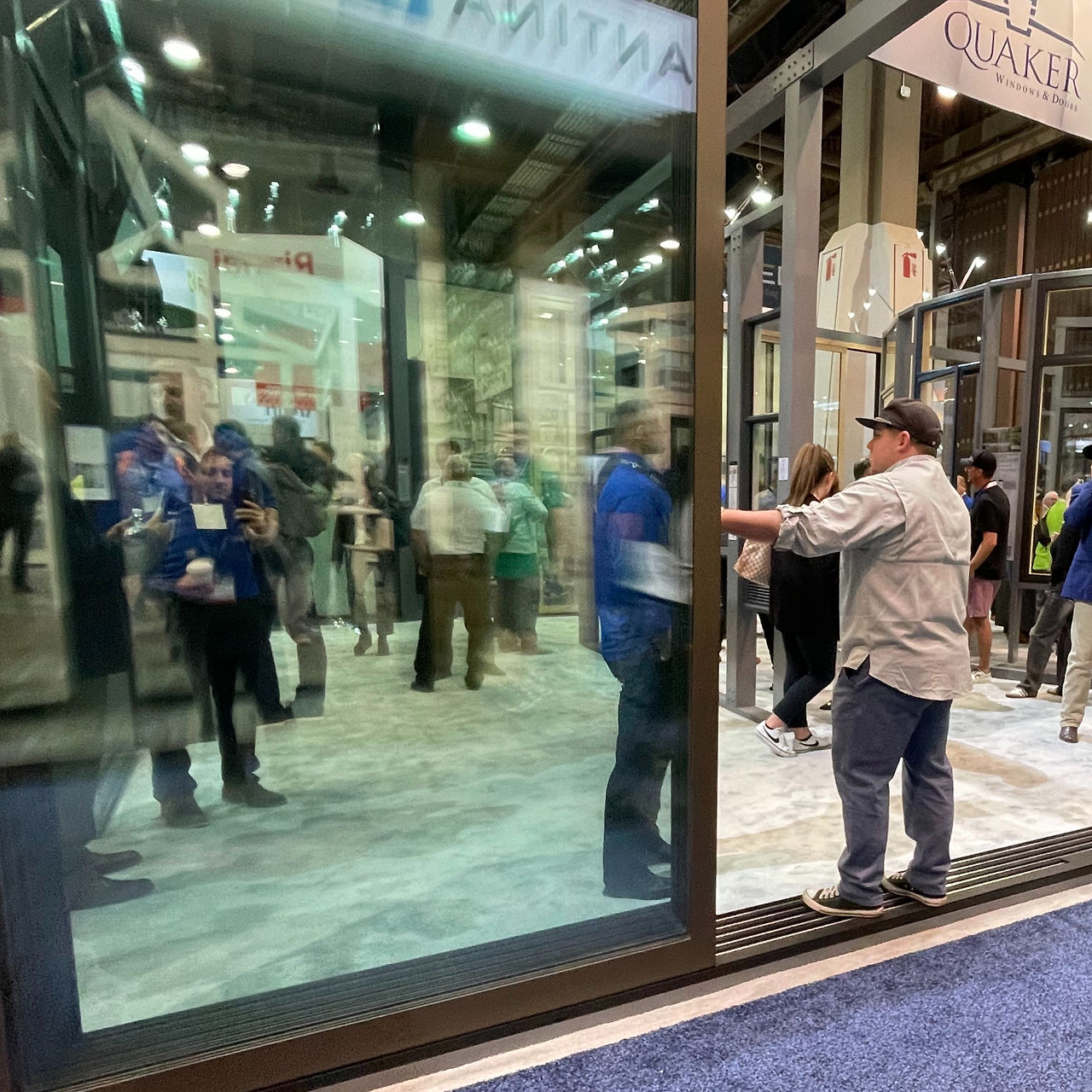 Guy opening large glass door