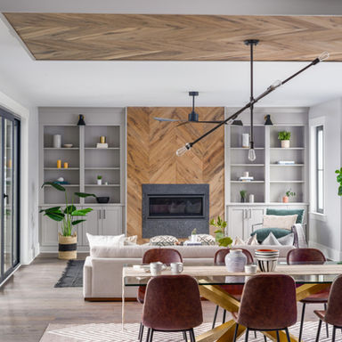 Meggett waterfront estate with a white oak chevron ceiling and fireplace wall, stone hearth and grey built-ins