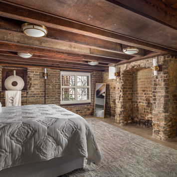 Charleston historic district restoration with original brick walls, a segmental arch and hand-hewn timber beams