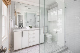 White bathroom with full glass walk in shower