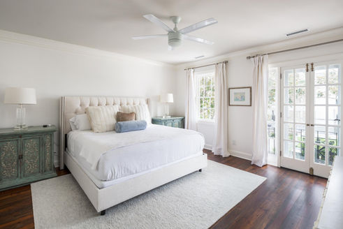 Large bedroom with french doors leading to courtyard