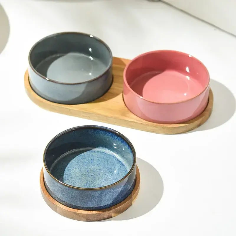 Ceramic cat food and water bowls on wooden stands