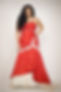 Dark-haired, in a red dress and pearls.