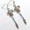 Thumbnail: Turtle Spirit Earrings with Feather in Silver Tone Metal Original Design