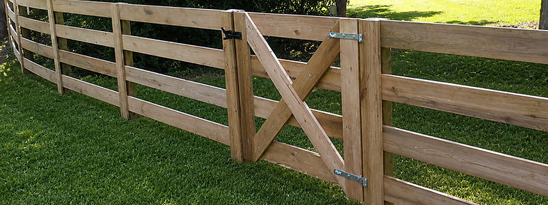 Four board fence with gait at a horse property in Reddick