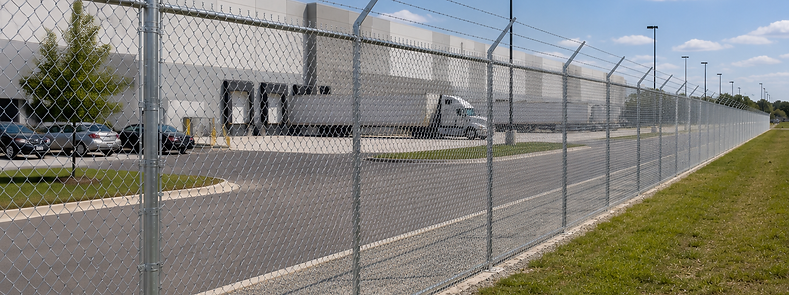 Chainlink security Fence with barb wire top protecting a warehouse in Gainesville, Florida