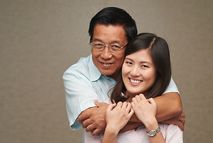 loving-family-looking-at-camera-CZE4QWS.