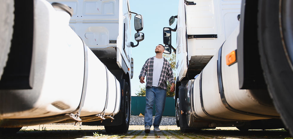 Truck driver walking between two large semi trucks
