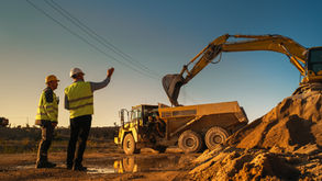 heavy construction equipment with workers