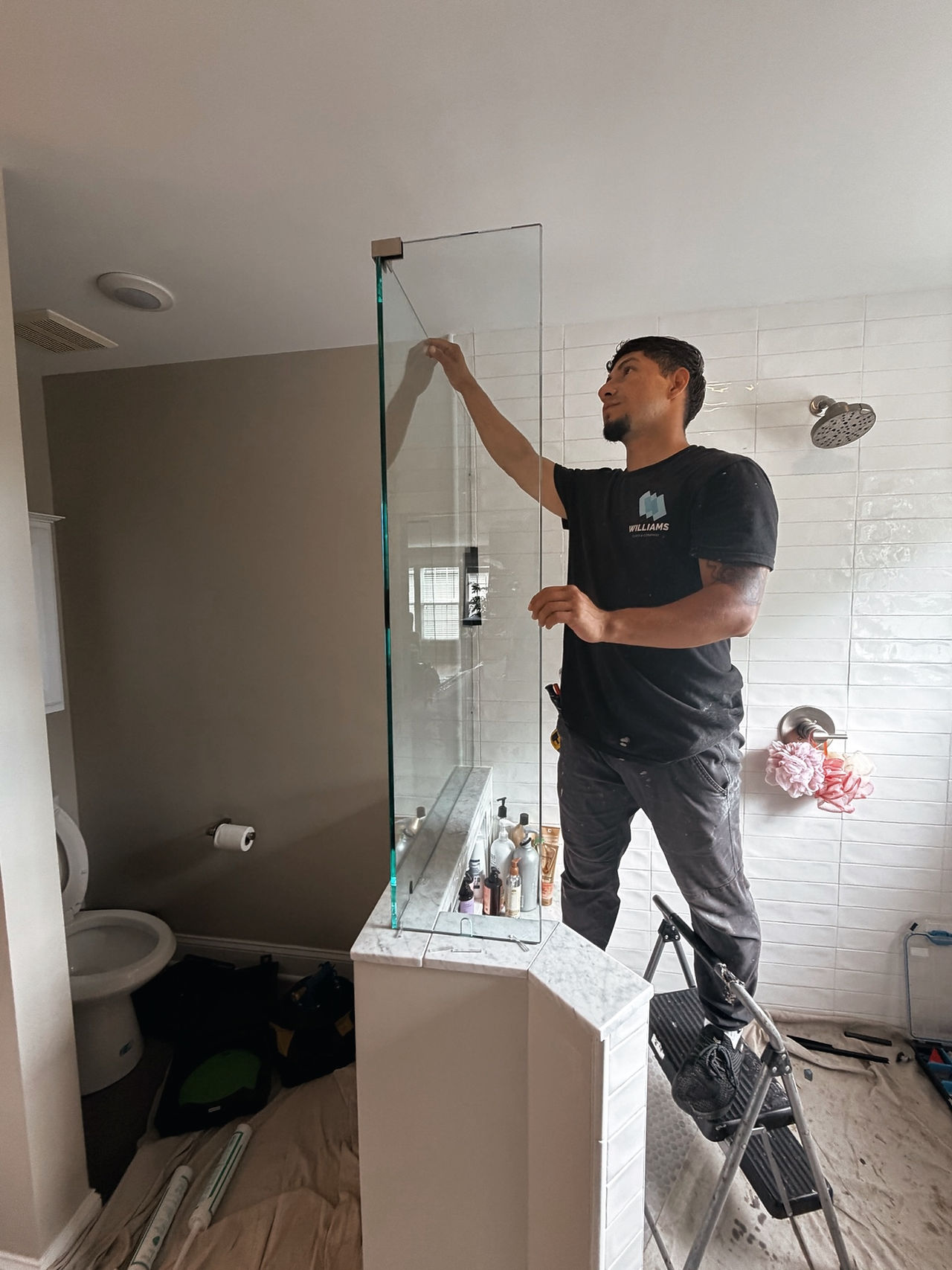 Williams Glass and Company technician installing frameless shower glass in Middletown MD