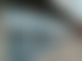 Completed commercial storefront with aluminum framing and glass panels on a new construction building.