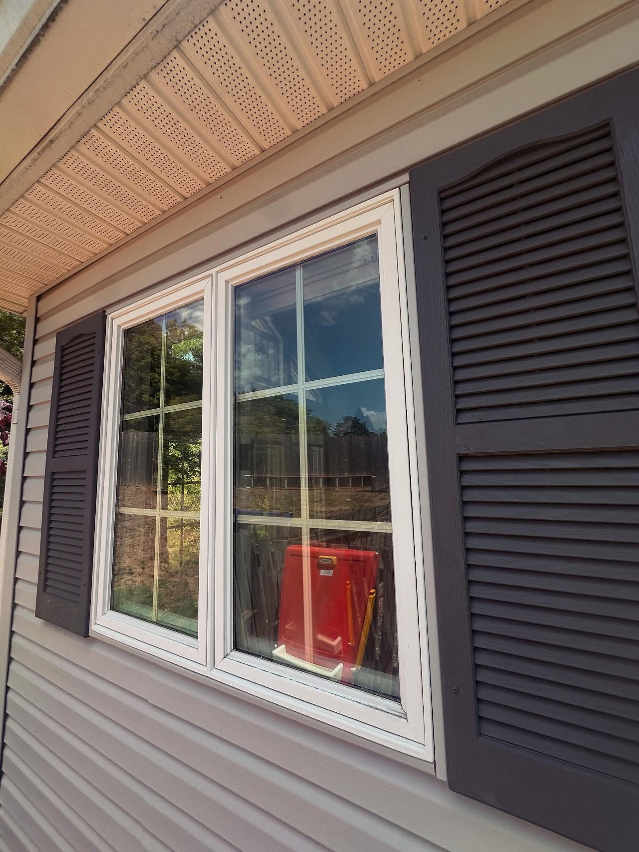 Foggy exterior window glass with condensation between double-pane units indicating seal failure.