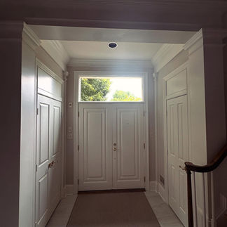 Interior photo of updated entryway with clear transom glass replacing stained glass in Potomac, MD home.