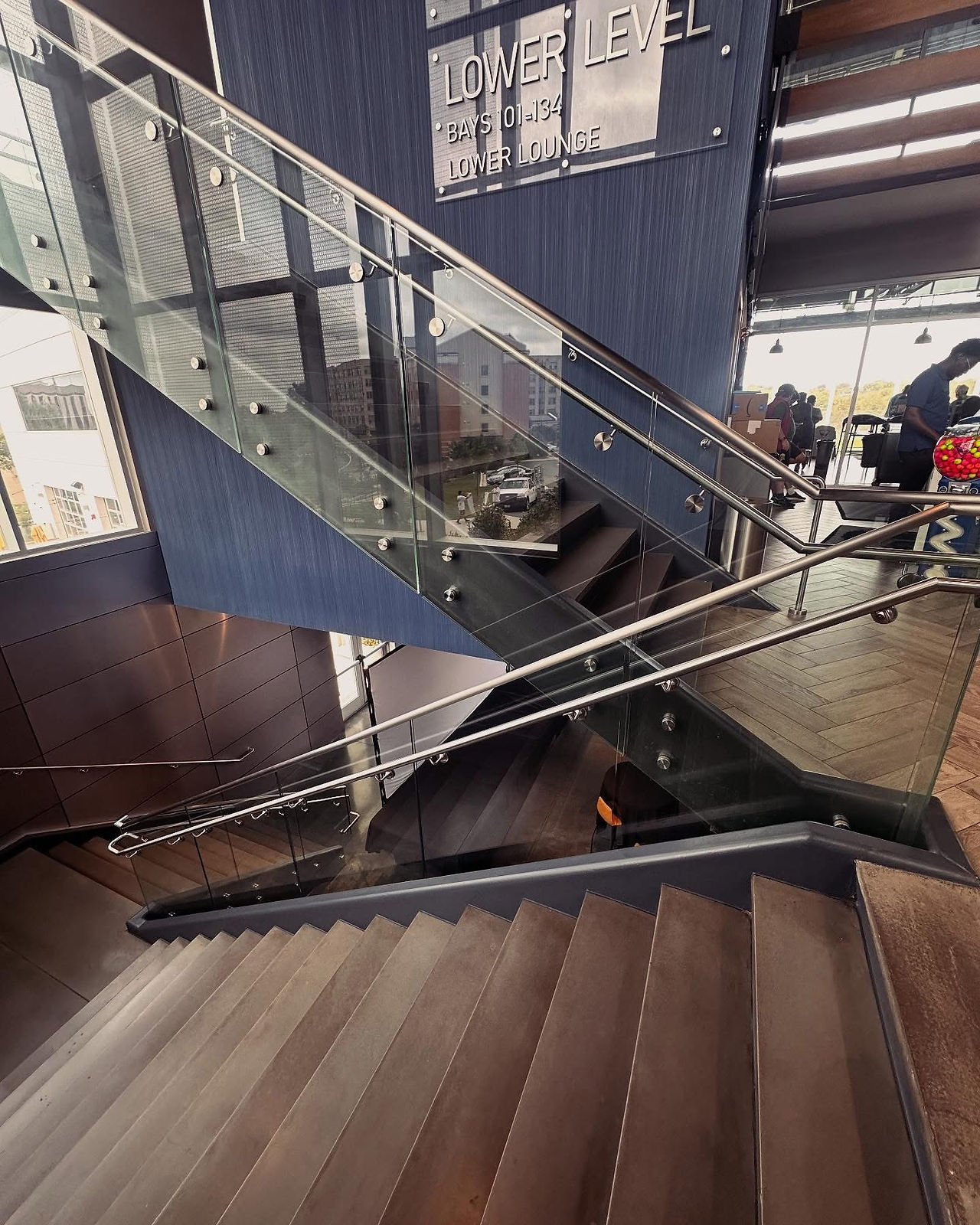 Completed handrail glass replacement at Topgolf Germantown, MD shown from lower stair angle.