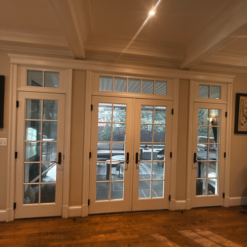 Interior view before French door replacement Chevy Chase MD showing original door and transom