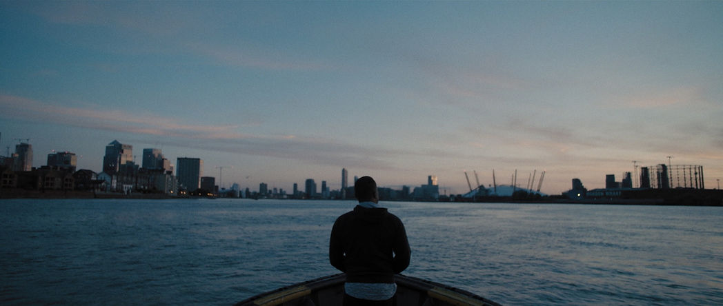 Commercial - BMW Art Journey - See The Unseen - Jamal Cyrus sailing on a boat with the London skyline in the horizon