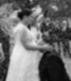 Newlyweds laughing under a shower of confetti during their wedding celebration