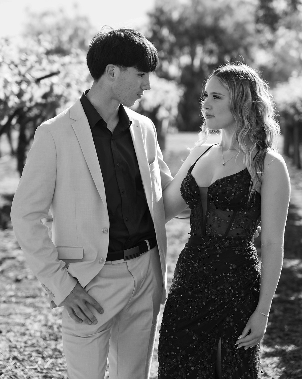 Young couple embracing in a vineyard for formal photos in Emerald