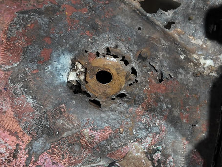 Severely rusted floor pan before professional metal replacement in Houston, Texas