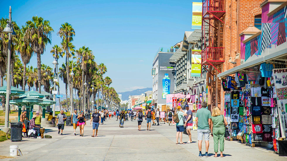 Venice Beach Boardwalk with lots of tourists and shops during a nice sunny day.