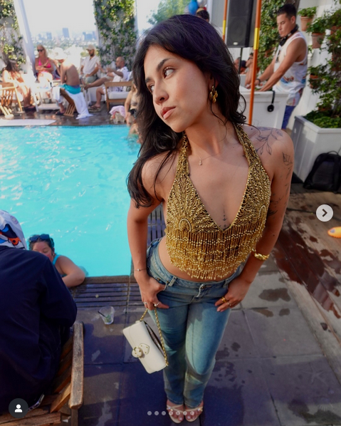Adriana wearing Community Thrift from West Covina's trendy clothes at a pool party event.