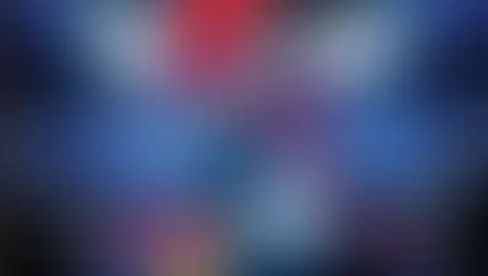 Two street dancers compete in front of a roaring stadium crowd.