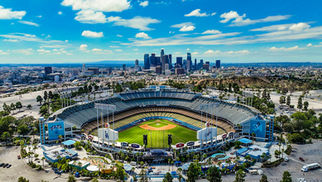 March 2025 in Los Angeles Cover Photo with Dodger Stadium as the focus in front of DTLA skyline on a bright sunny day.