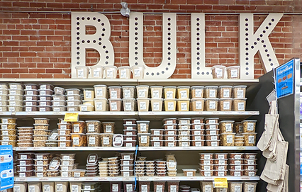 Pantry goods in clear Friendlier containers on a shelf in the bulk section of The Sweet Potato