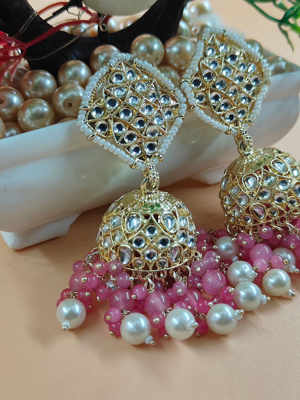 Thumbnail: One of the most enchanting aspects of Jhumka earrings is the dangling elements that hang below the domes.
