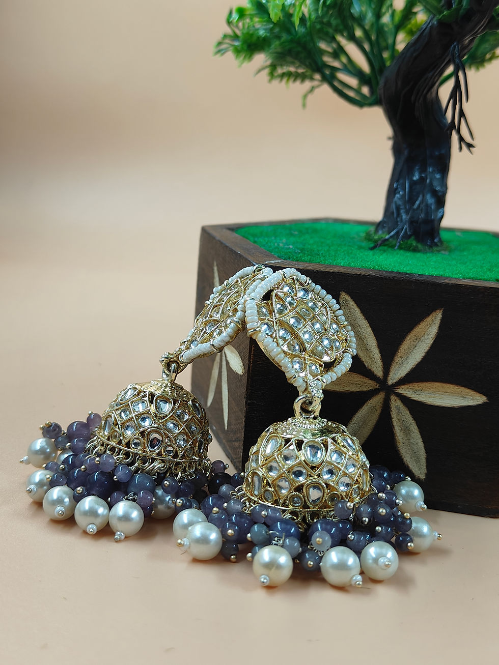 Thumbnail: One of the most enchanting aspects of Jhumka earrings is the dangling elements that hang below the domes.