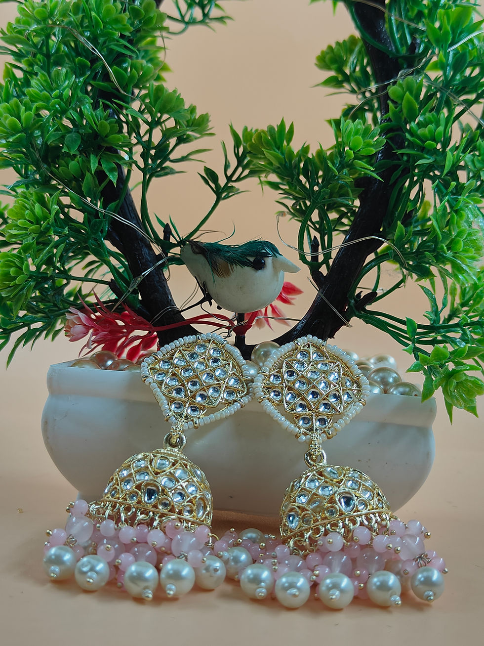 Thumbnail: One of the most enchanting aspects of Jhumka earrings is the dangling elements that hang below the domes.