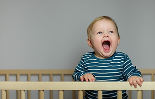 Baby pulling to stand in the crib, a developmental milestone that can temporarily affect sleep