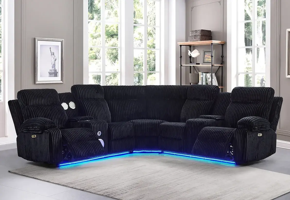 Black sectional sofa with blue LED lights in modern living room.