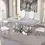 Thumbnail: Luxurious dining table, marble top, chrome base, four white chairs.