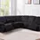 Thumbnail: Black ribbed sectional sofa with recliners, cup holders in living room.