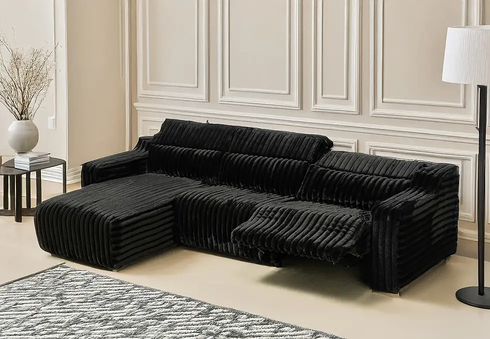 Thumbnail: Black ribbed modular sofa in a room with white paneled walls.