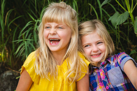 Sibling family photography capturing natural laughter and connection