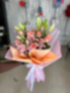 Experience serenity with Tranquil Notes Flower Bouquet, featuring a captivating blend of lilies and roses