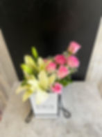 A beautiful Mixed Bouquet of pink roses and lilies in a rectangular box.