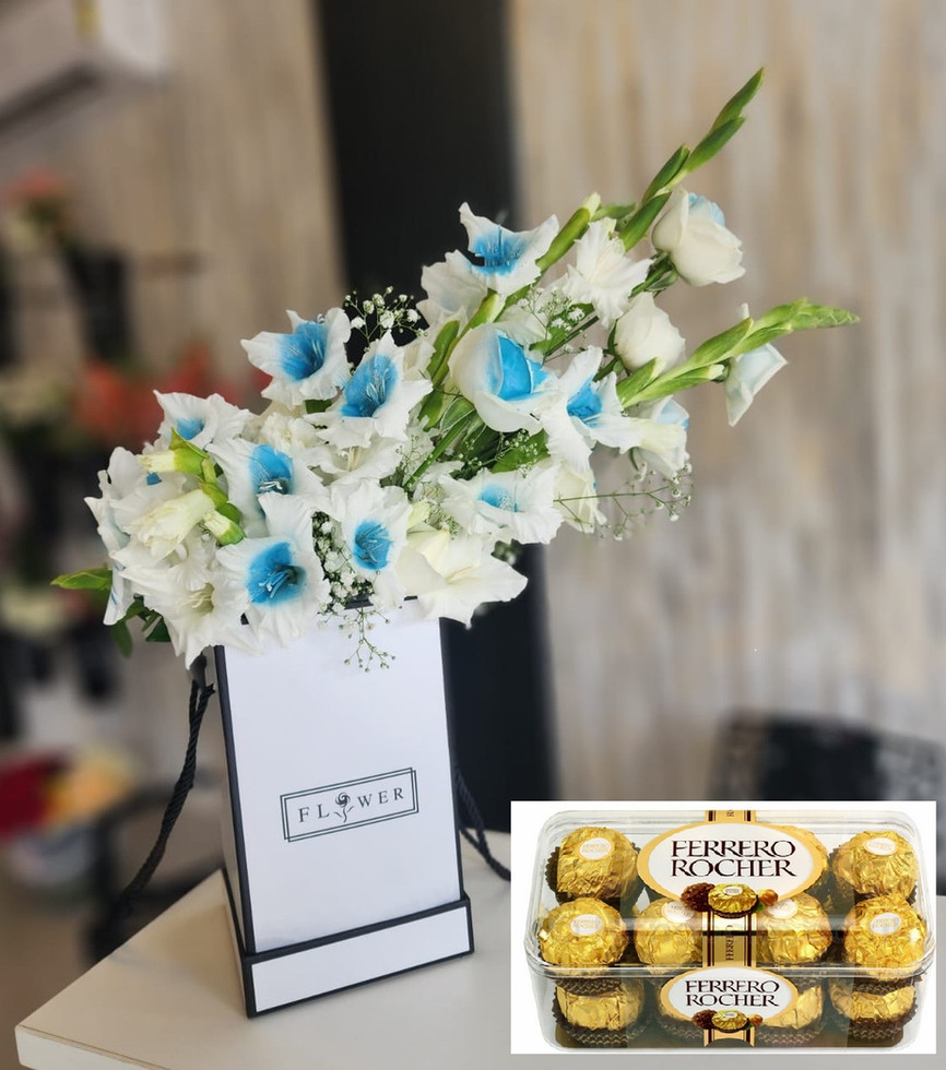 Discover solace in Solace (Azure) Flowers, a luxurious arrangement of Roses, lilies elegantly presented in a stylish box
