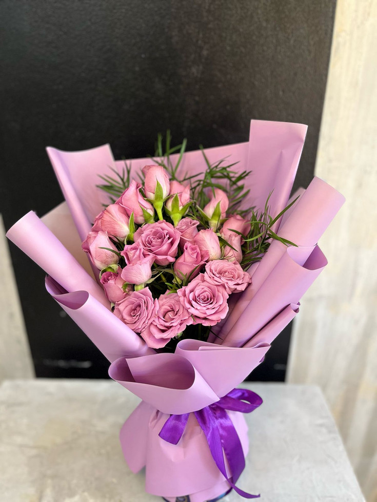Experience enchantment with Purple roses Flower Bouquet, featuring a blend of exquisite flowers