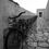 Miniatura: Black and white photo of a bicycle by the yellow wall of Izamal Convent – minimalist travel photo and wall decor.