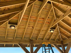 Tideline Electric can light installation on a gazebo at the end of a wooden pier.