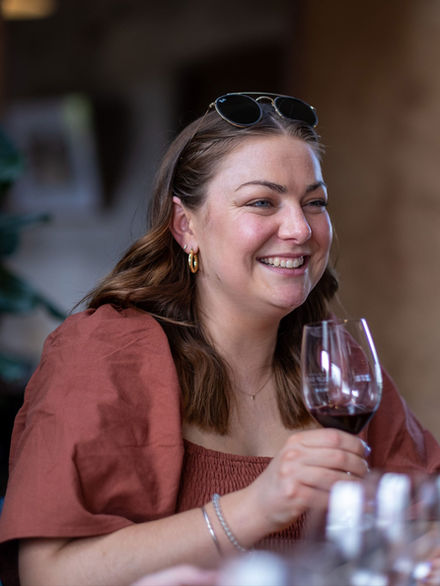 Woman enjoying wine tasting tour at cellar door in Orange NSW