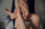 Hands manipulating a person's feet and lower legs