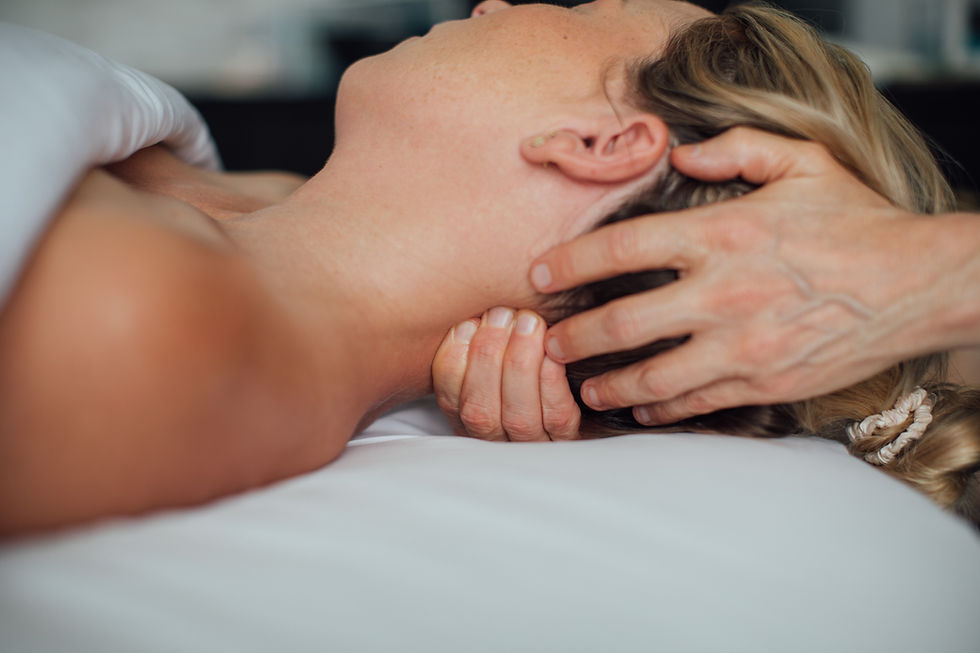 Person relaxing in a minimalist wellness studio with soft ambient lighting and organic textures